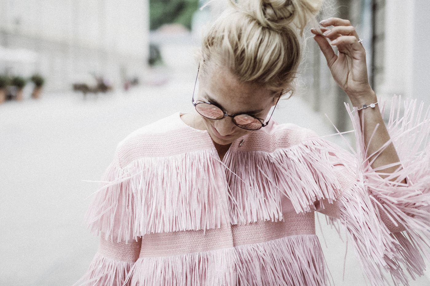 Woman wearing a fun pink jacket.