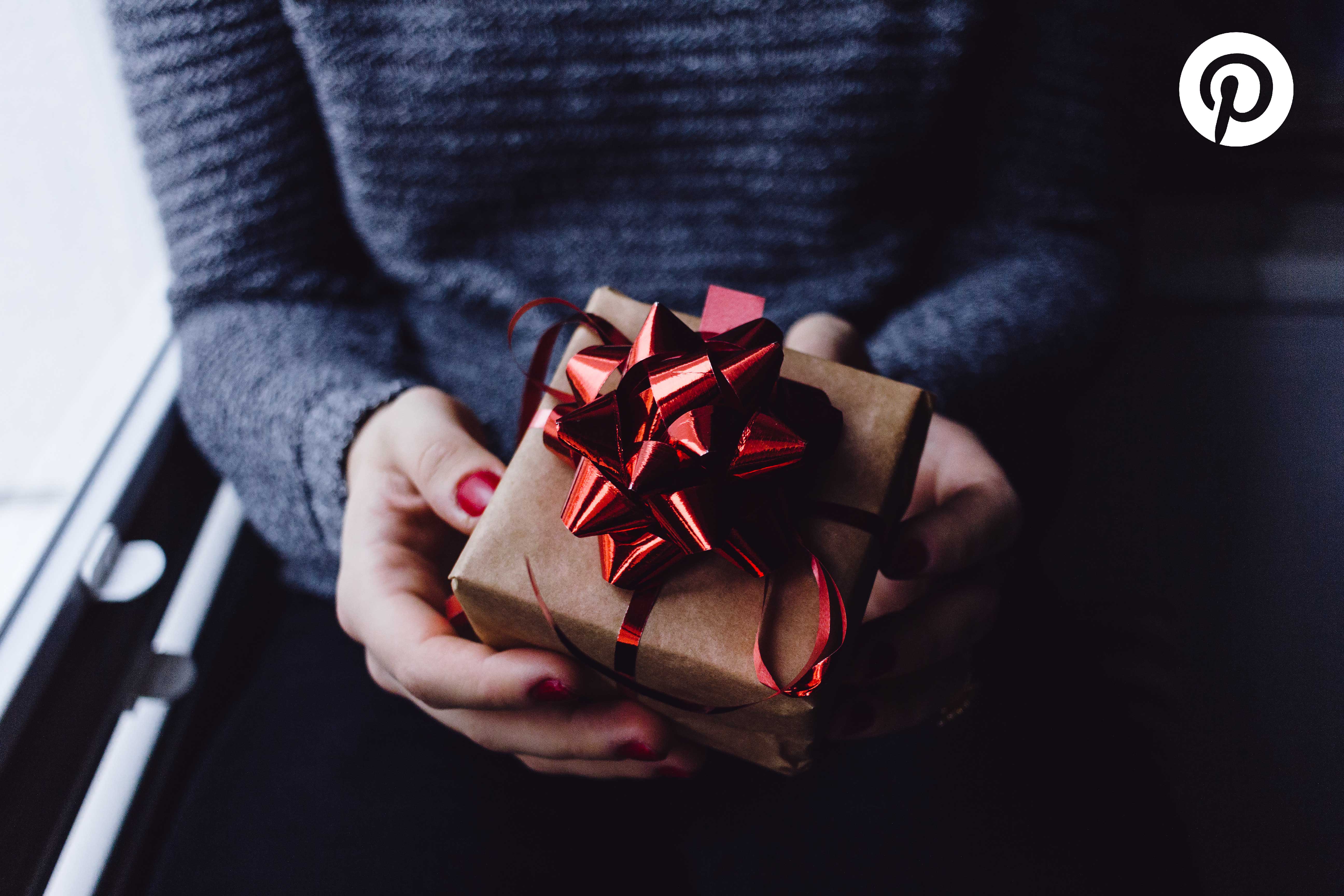 Picture of 2 hands holding a wrapped gift 