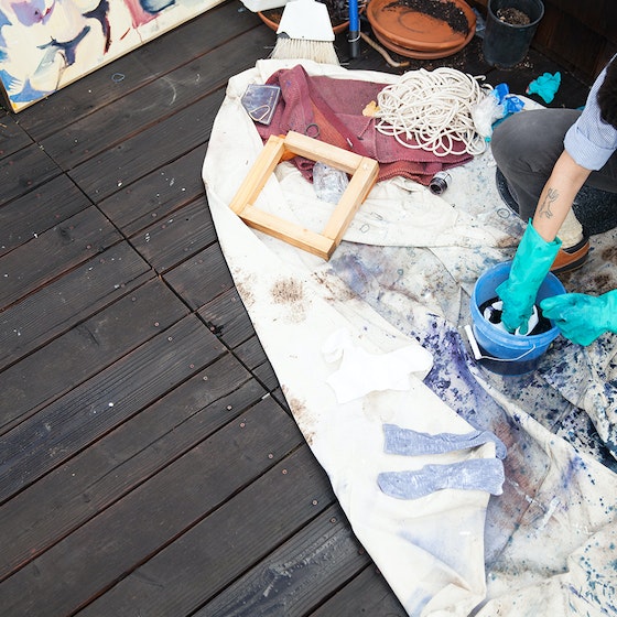 Woman doing crafts on deck.