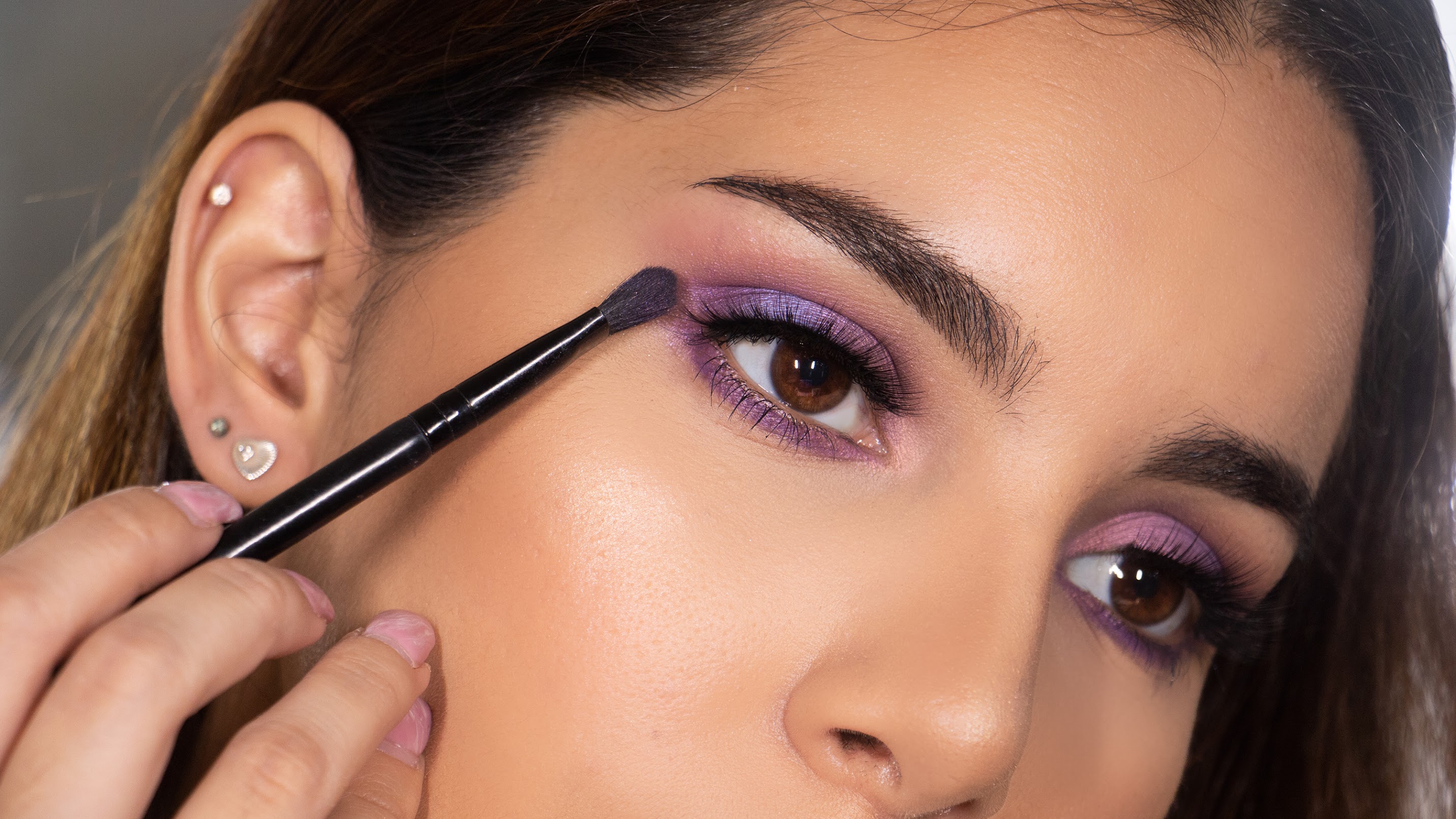 Photo of woman putting eye shadow