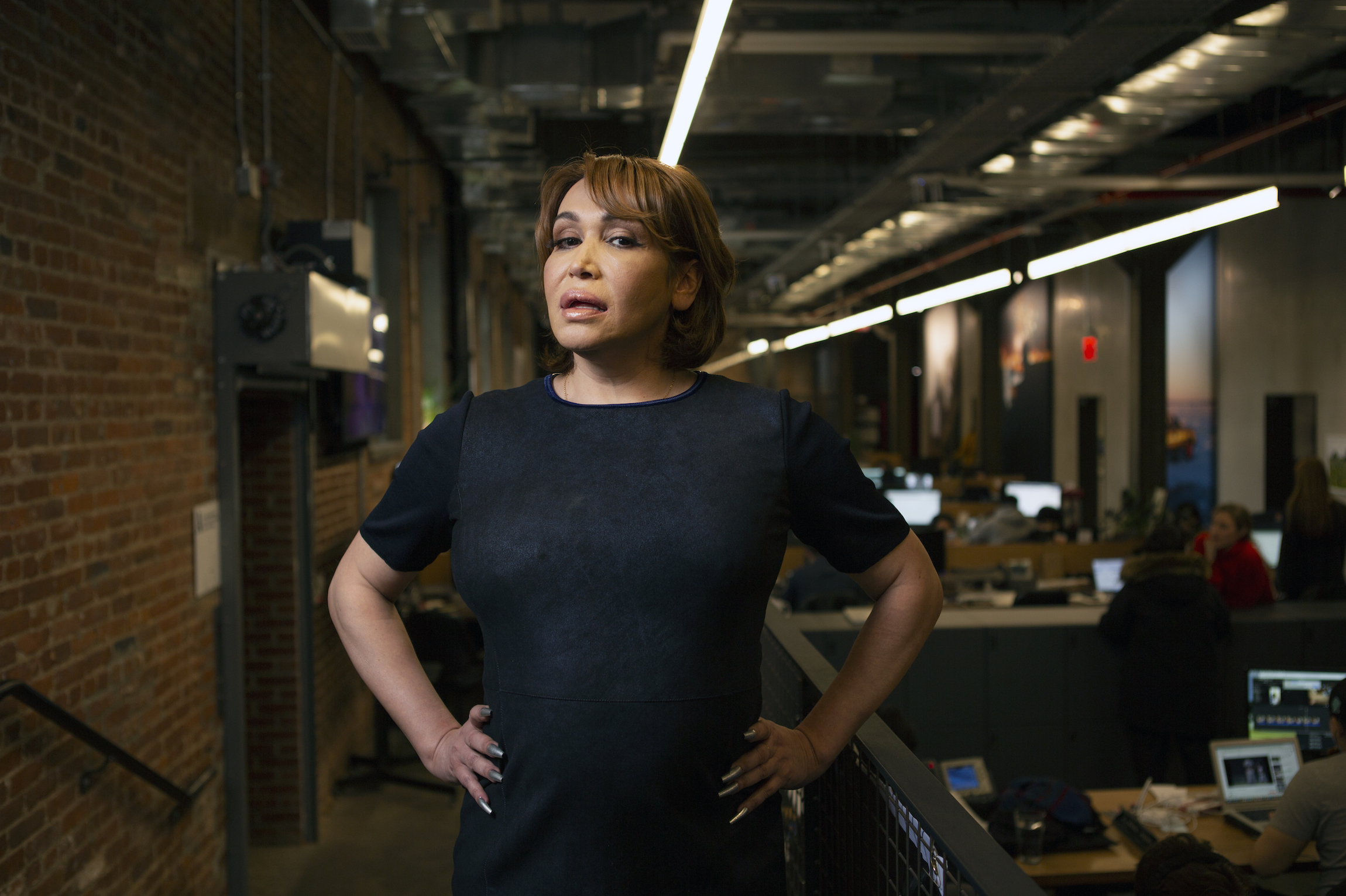 Trans woman standing proud in office setting